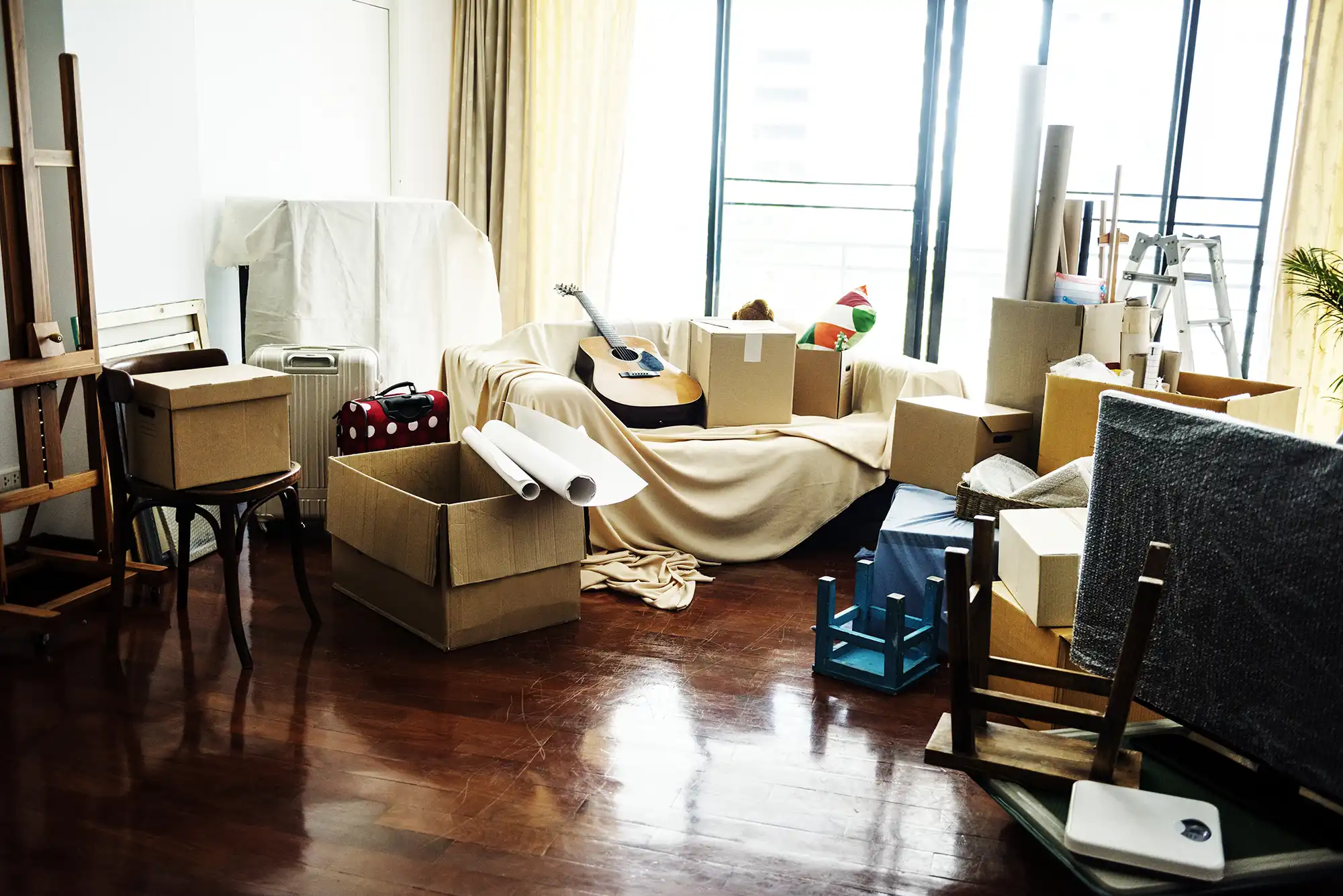 Moving day, cleaning services, boxes in a living room,