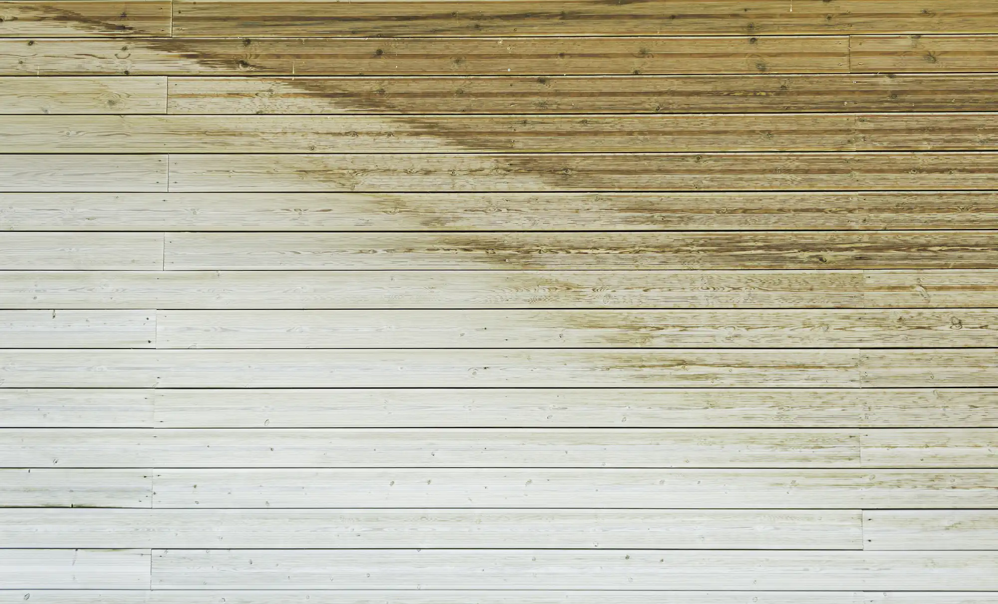 Partially cleaned wood surface showing the difference exterior washing can make